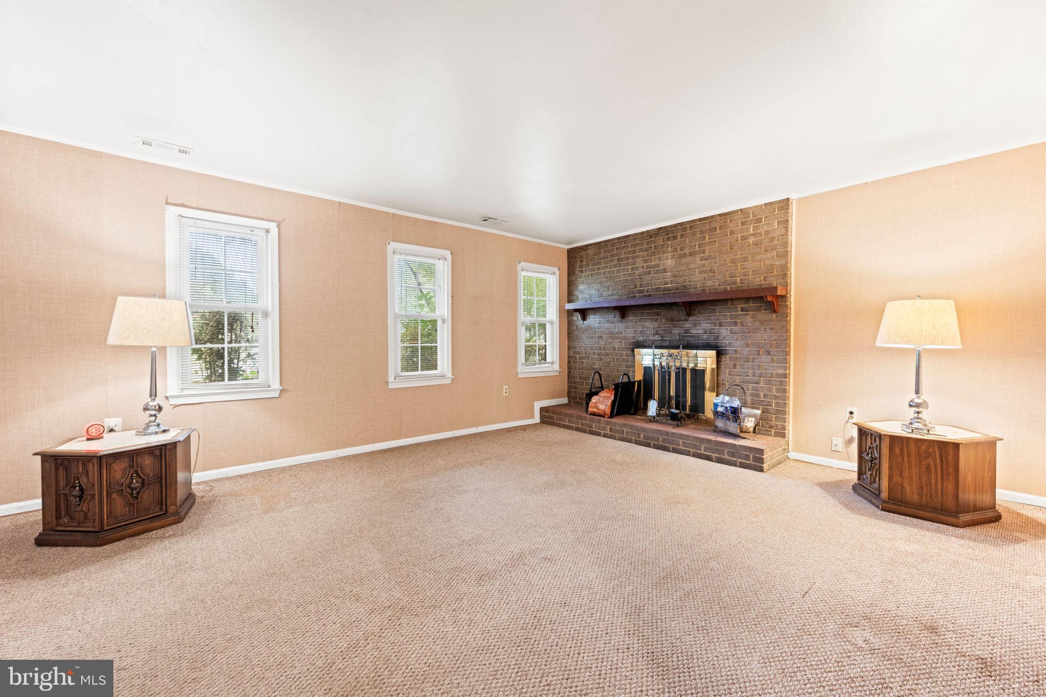 8000 Lady Lewis Court Springfield, VA 22153 - Photo 31 of 44 a livingroom with a fireplace and window
