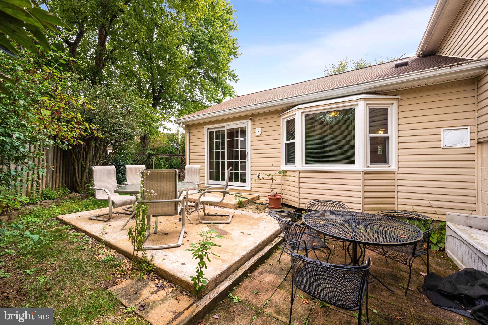 8000 Lady Lewis Court Springfield, VA 22153 - Photo 37 of 44 a view of a patio with table and chairs with wooden floor and fence