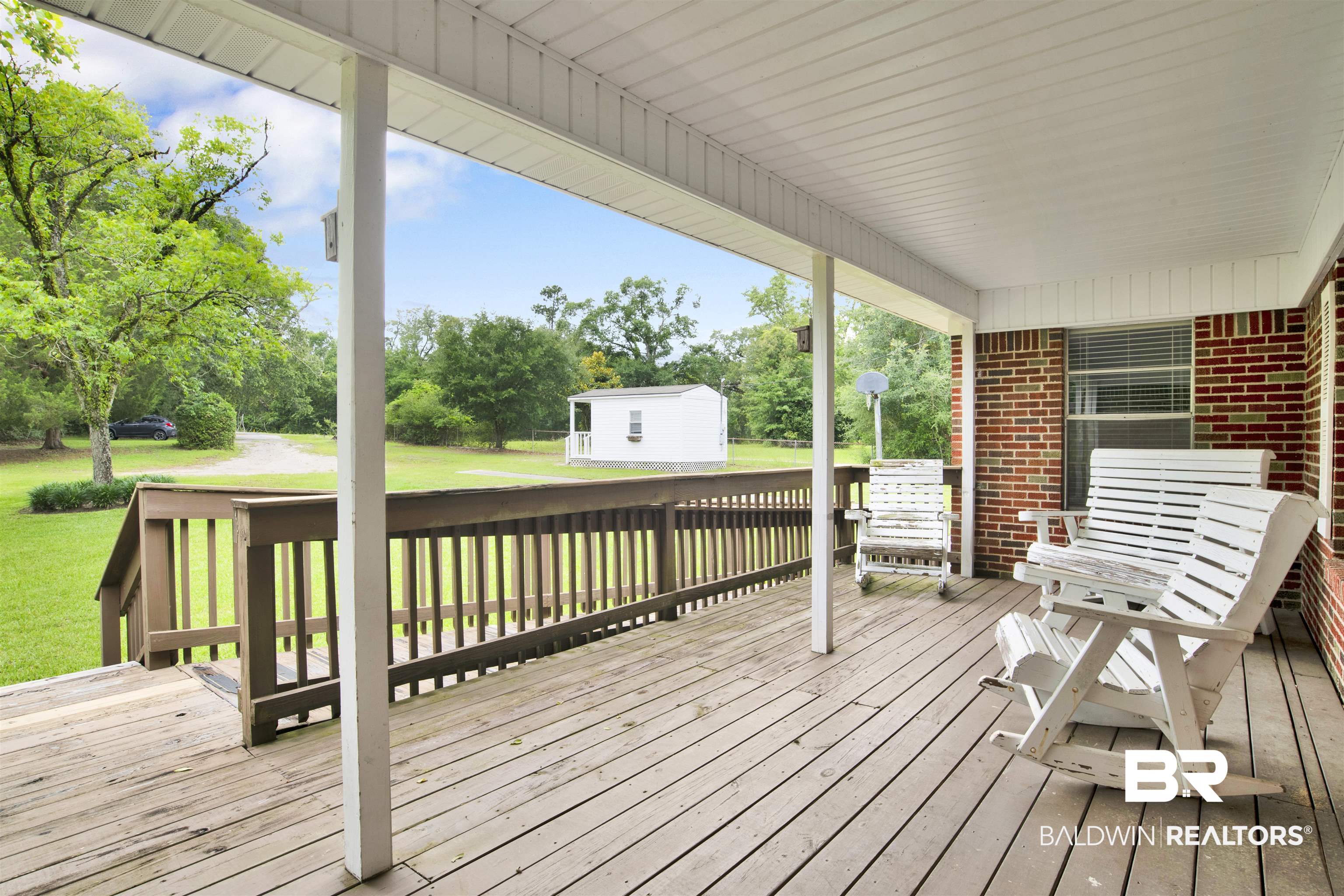17714 Horseneck Road Bay Minette, AL 36507 - Photo 4 of 36 Spacious covered porch with wood decking and white support columns