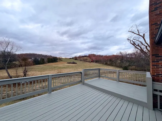 a view of a balcony with wooden floor and city view