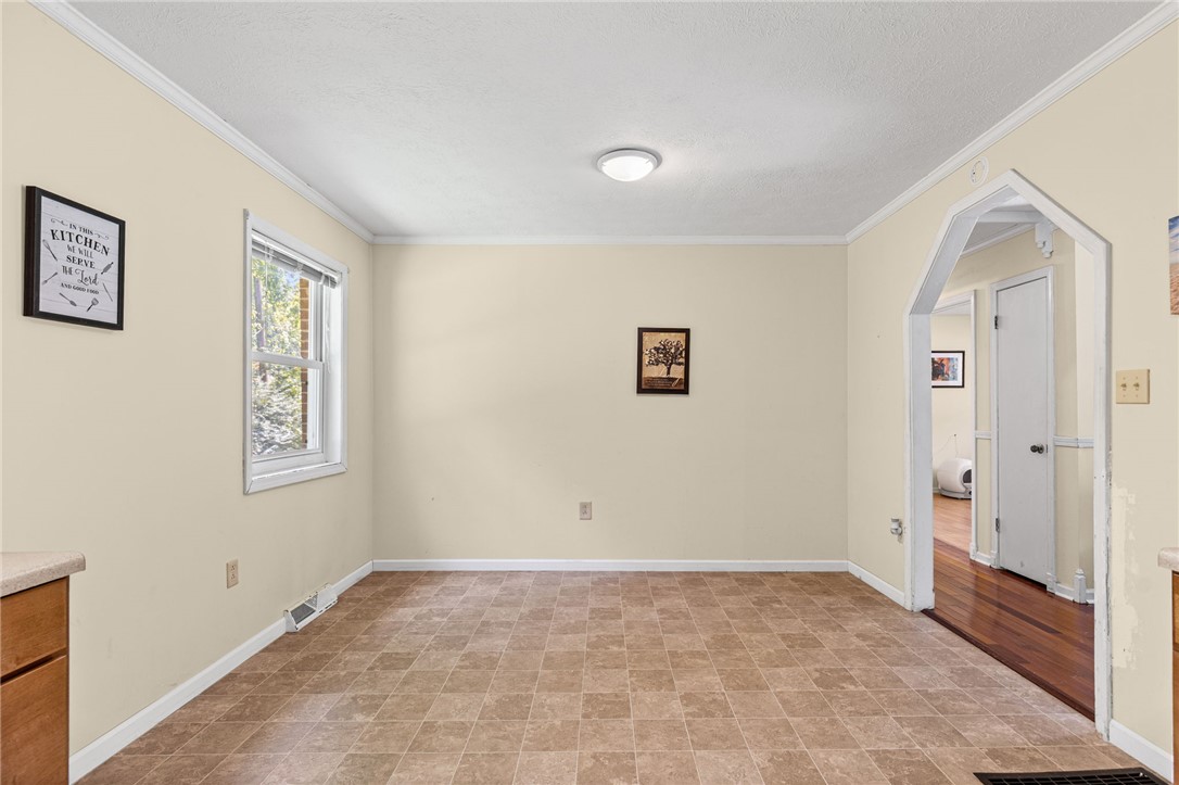 322 Tribble Street Honea Path, SC 29654 - Photo 17 of 35 An arched doorway connects this casual dining space to the adjacent hallway.