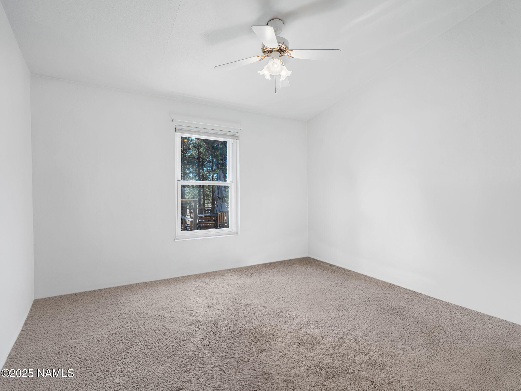 13112 Fallow Deer Road Parks, AZ 86018 - Photo 17 of 39 an empty room with a window and a ceiling fan