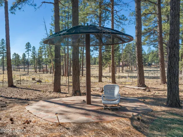a patio with a yard table and chairs