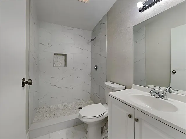 a bathroom with a sink toilet and shower