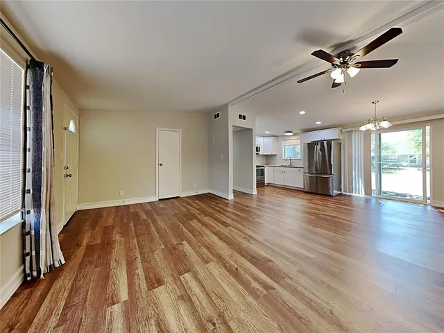 wooden floor in an empty room with a window