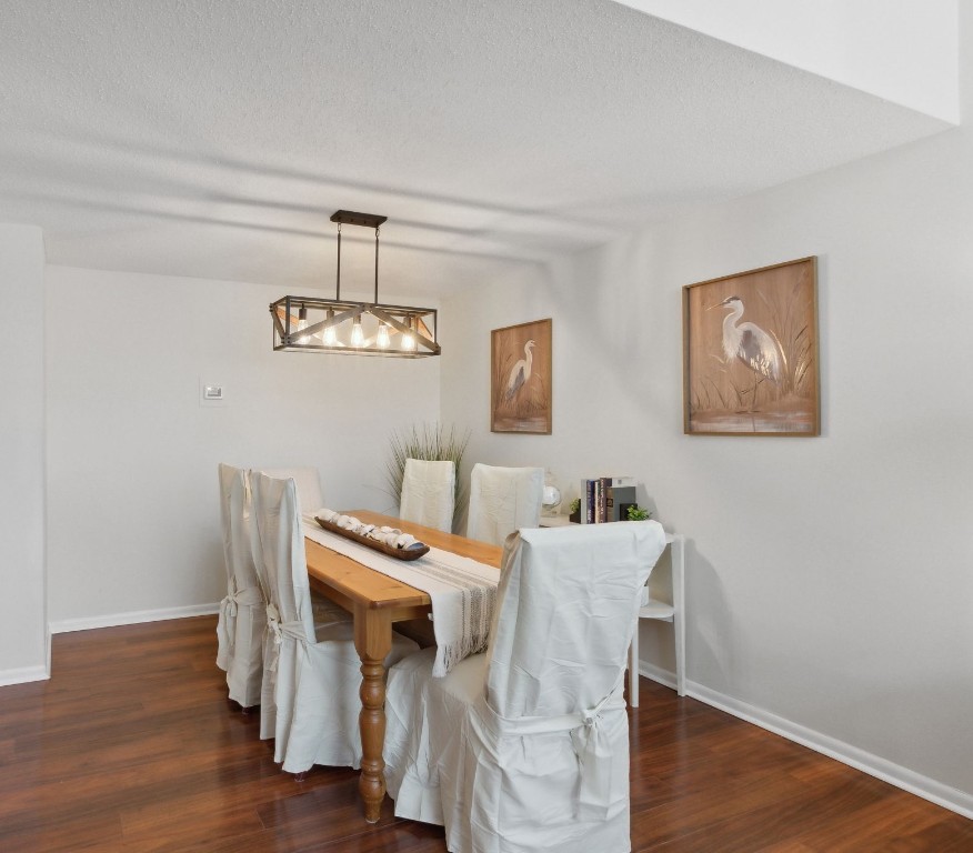 1163 Beach Walker Road, Unit 1163 Fernandina Beach, FL 32034 - Photo 17 of 58 a view of a dining room with furniture wooden floor and a chandelier