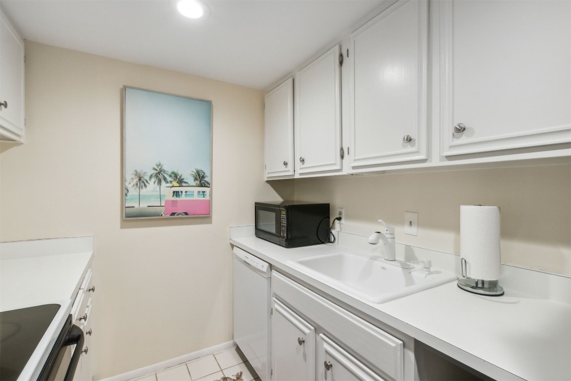 1163 Beach Walker Road, Unit 1163 Fernandina Beach, FL 32034 - Photo 21 of 58 a kitchen with stainless steel appliances a sink a stove and cabinets
