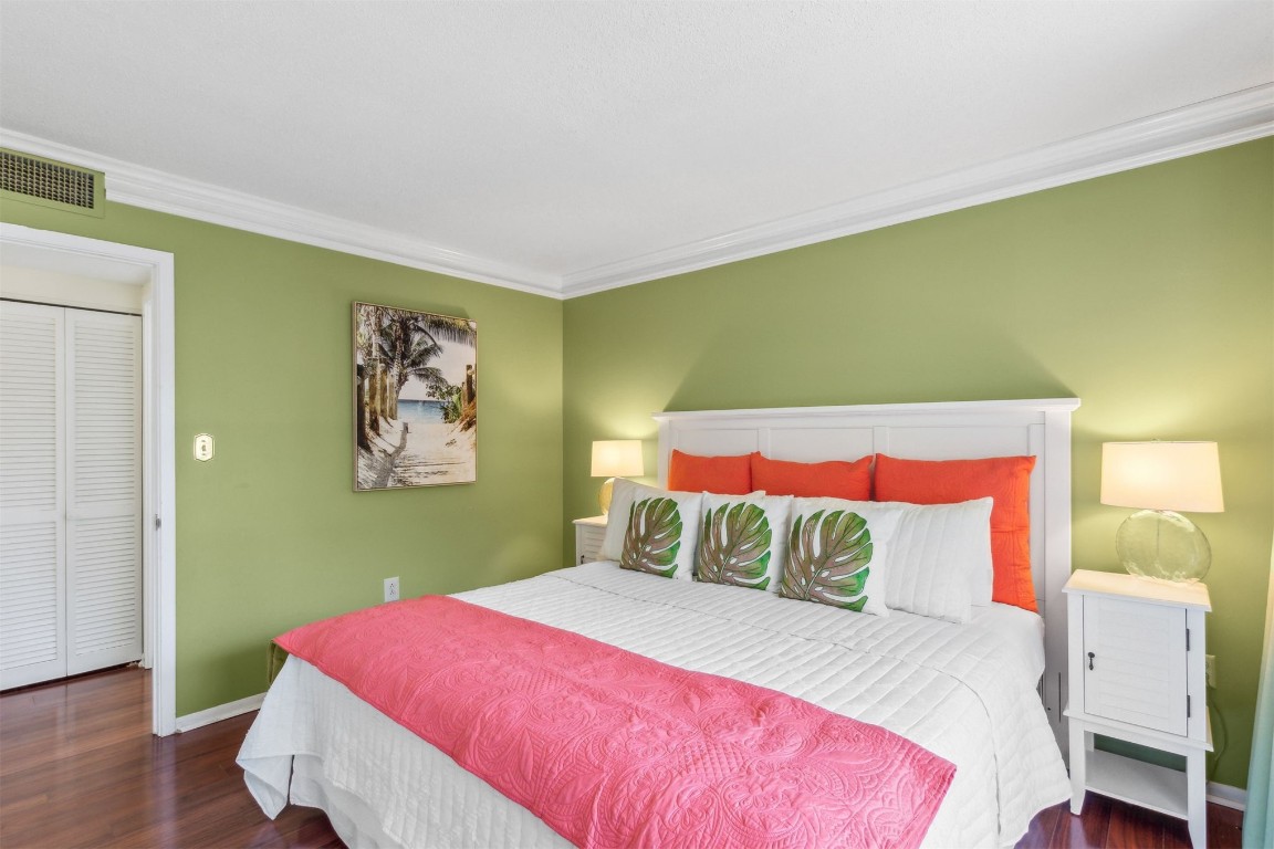 1163 Beach Walker Road, Unit 1163 Fernandina Beach, FL 32034 - Photo 23 of 58 a bedroom with a bed and wooden floor