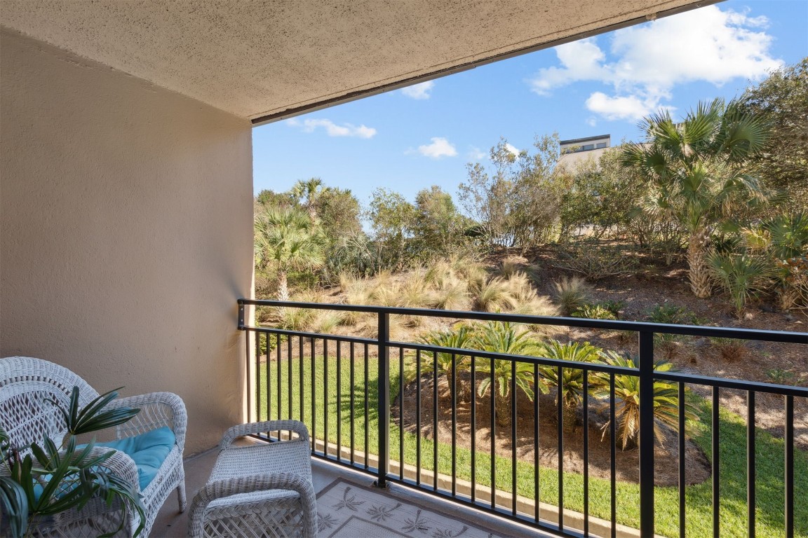 1163 Beach Walker Road, Unit 1163 Fernandina Beach, FL 32034 - Photo 25 of 58 a view of a balcony with couches and wooden floor