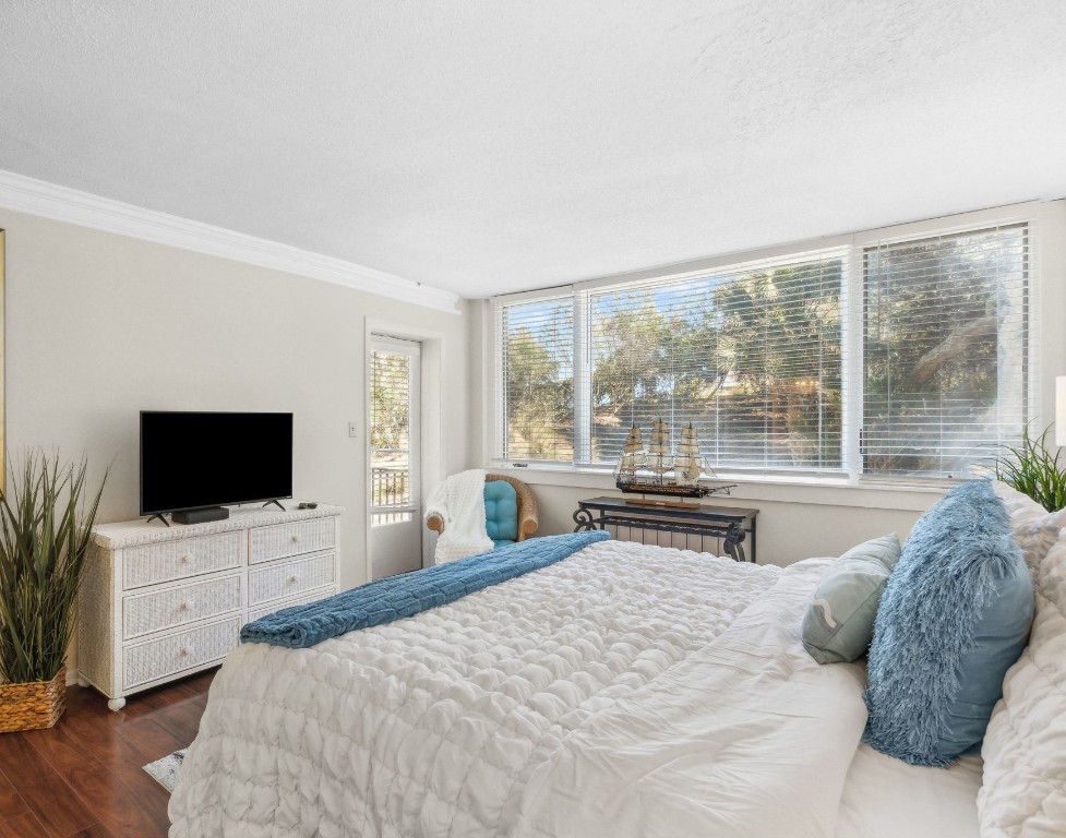 1163 Beach Walker Road, Unit 1163 Fernandina Beach, FL 32034 - Photo 31 of 58 a bedroom with a large bed and a flat tv screen on dresser