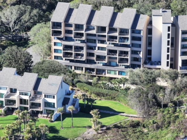 1163 Beach Walker Road, Unit 1163 Fernandina Beach, FL 32034 - Photo 35 of 58 a view of a large building with a yard and plants