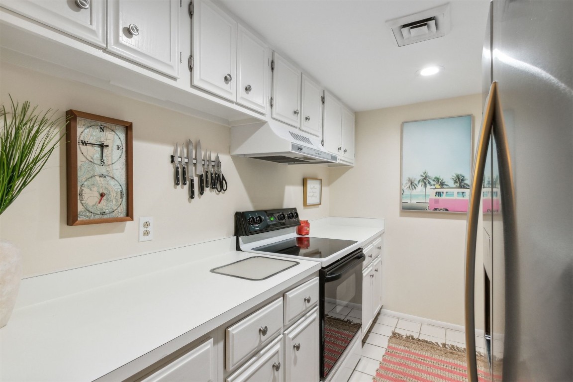 1163 Beach Walker Road, Unit 1163 Fernandina Beach, FL 32034 - Photo 7 of 58 a kitchen with appliances cabinets and a counter top space