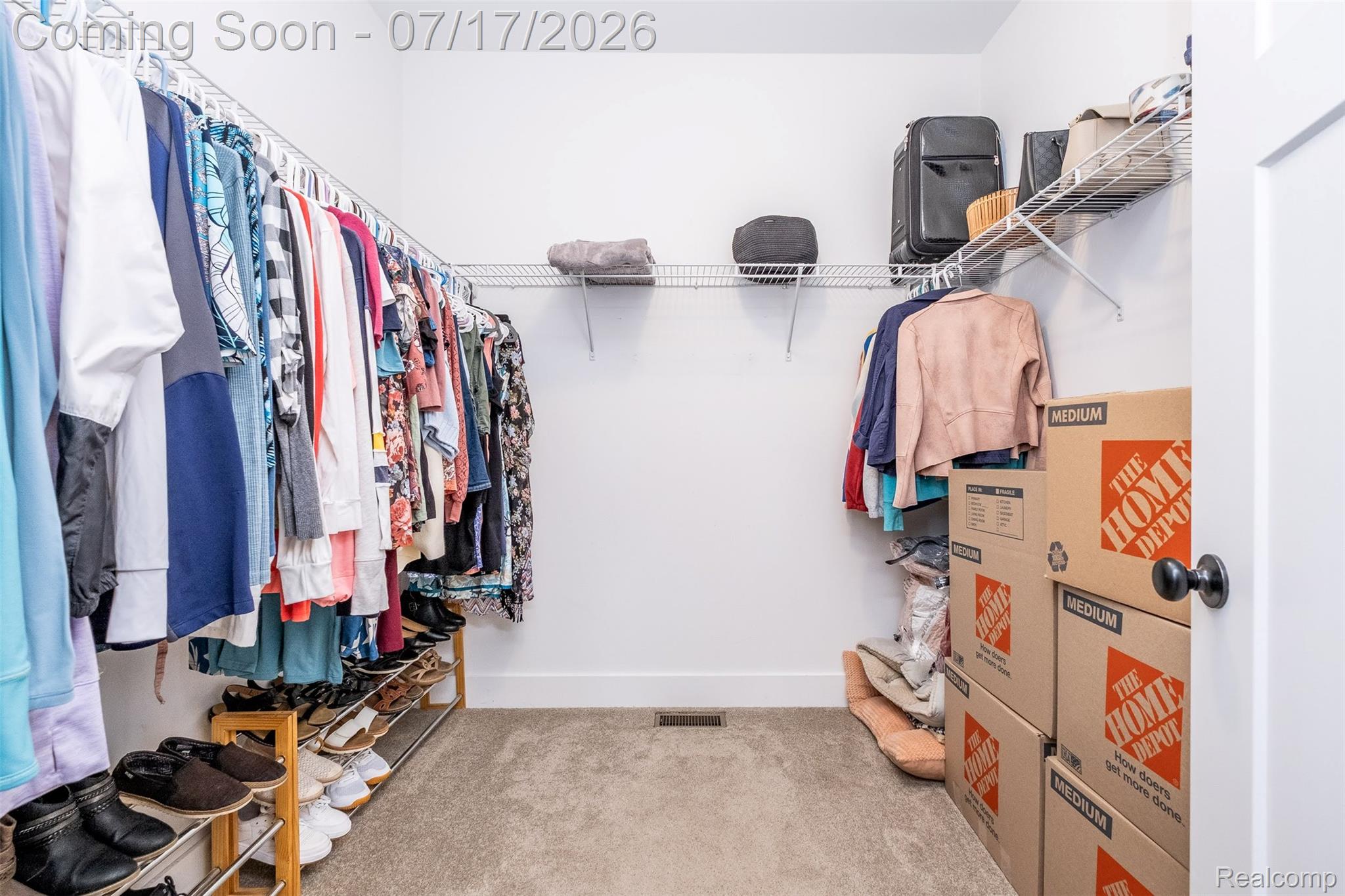 12349 Sugar Maple Drive Fenton, MI 48430 - Photo 30 of 67 Walk-in closet featuring extensive wire shelving, multiple hanging rods, and carpeting