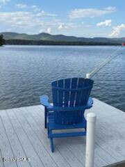 61 Tor Court Pittsfield, MA 01201 - Photo 15 of 32 a wooden bench sitting in front of a lake