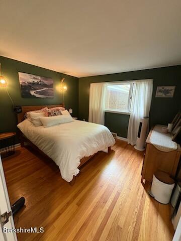61 Tor Court Pittsfield, MA 01201 - Photo 22 of 32 a bedroom with a bed and wooden floor