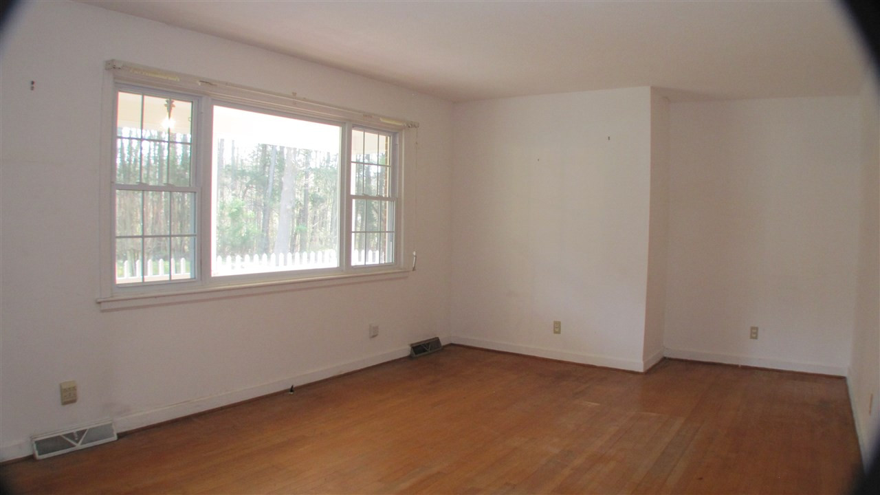 1210 Hamlin Road Durham, NC 27704 - Photo 5 of 18 The Family Room has Hardwood Floors and Ample Lighting. Family Room