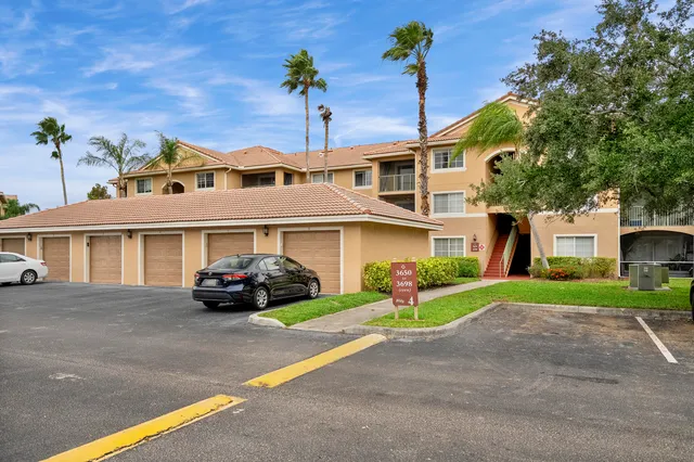 a front view of a house with a garden and plants