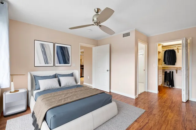 a bedroom with a large bed and a chandelier
