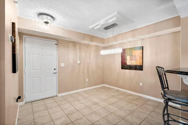 a view of a hallway with front door and wooden floor