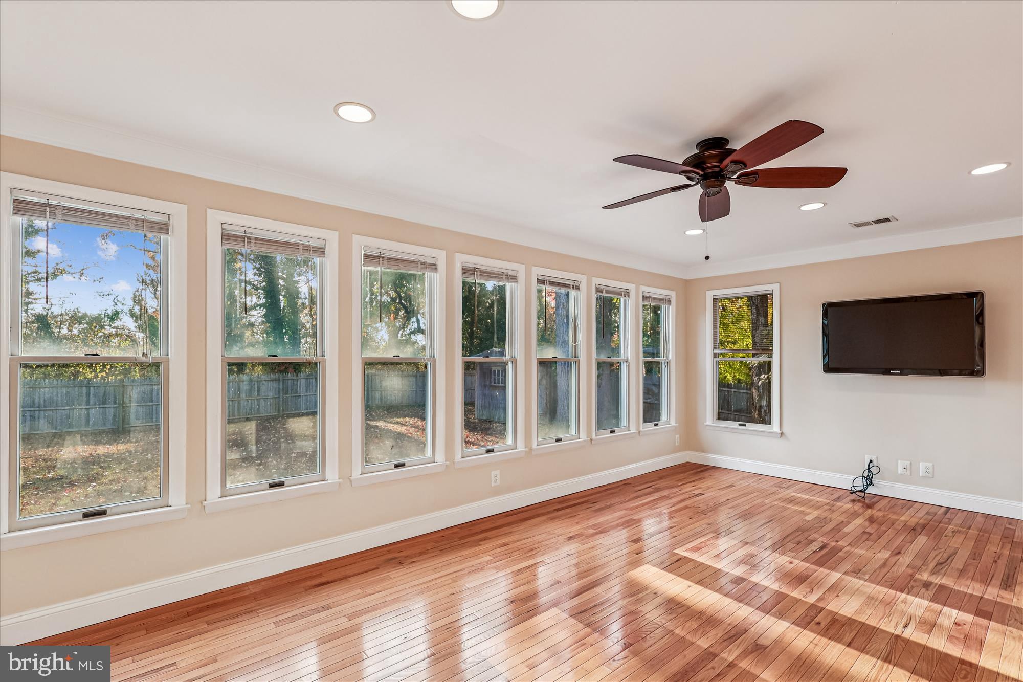 1506 Widows Mite Road Edgewater, MD 21037 - Photo 34 of 66 a view of a livingroom with a flat screen tv and a ceiling fan