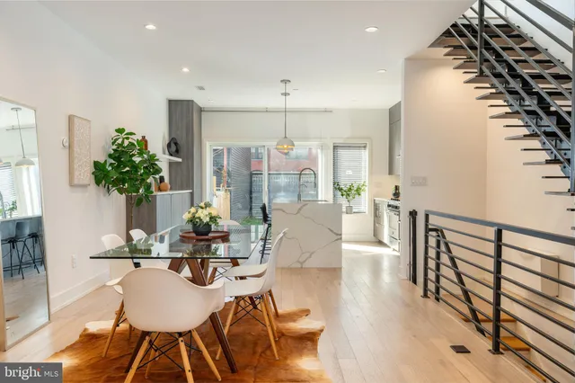 a living room with furniture potted plant and a table