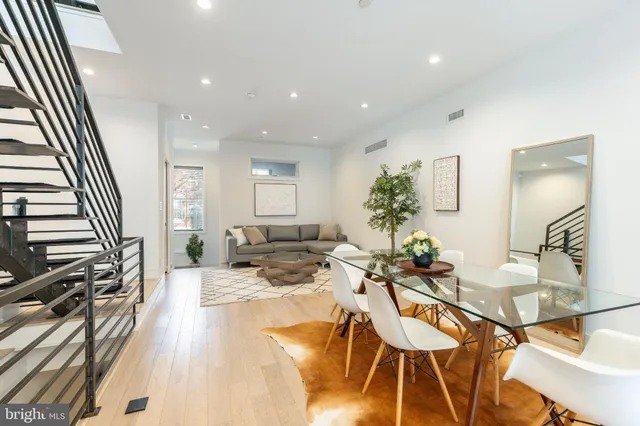 a kitchen with stainless steel appliances granite countertop white cabinets and a stove
