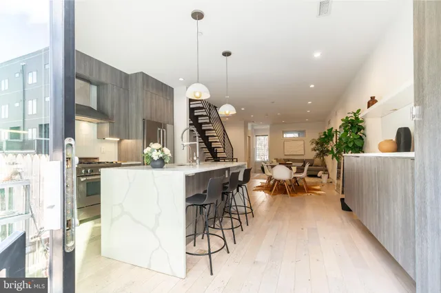 a dining room with furniture and wooden floor