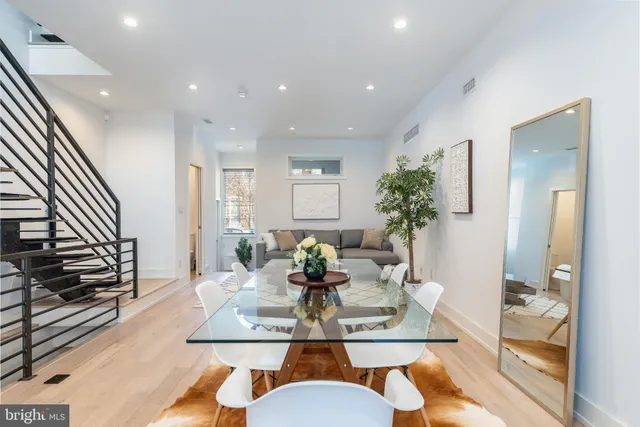 a bedroom with a large bed and potted plant