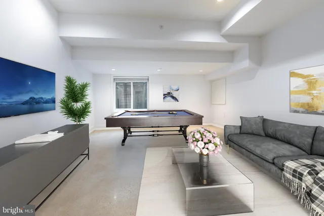 a view of an empty room with wooden floor and closet