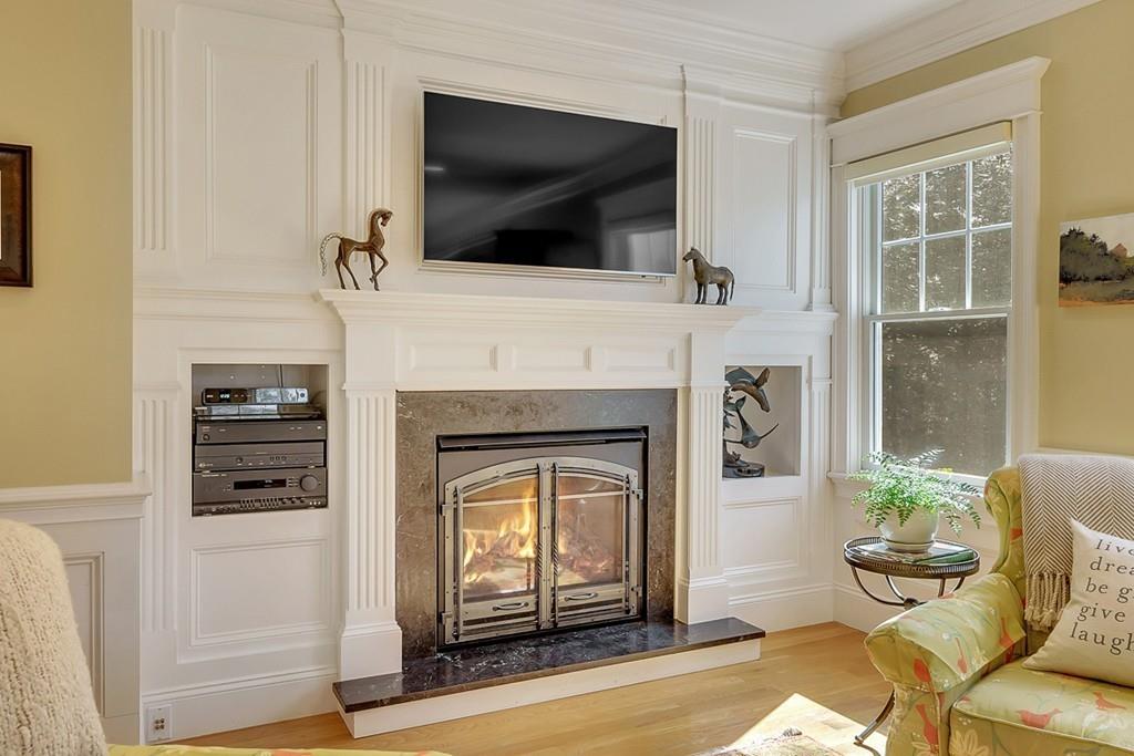 33 Everett Street Concord, MA 01742 - Photo 15 of 42 a living room with furniture a flat screen tv and a fireplace