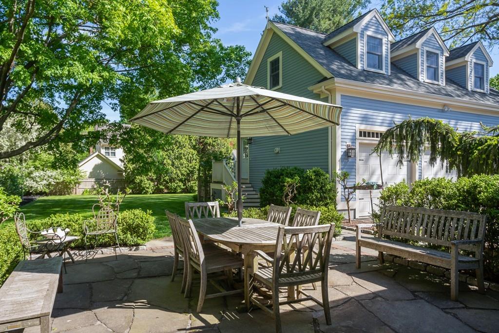 33 Everett Street Concord, MA 01742 - Photo 2 of 42 a view of a patio with a table and chairs under an umbrella