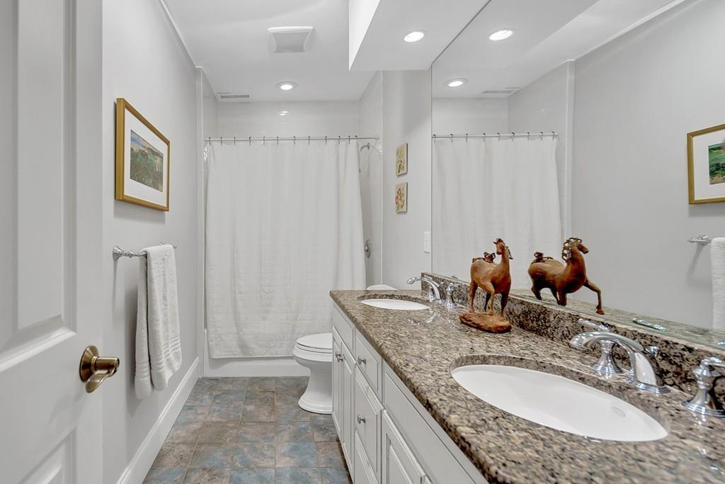 33 Everett Street Concord, MA 01742 - Photo 31 of 42 a bathroom with a granite countertop sink and a mirror