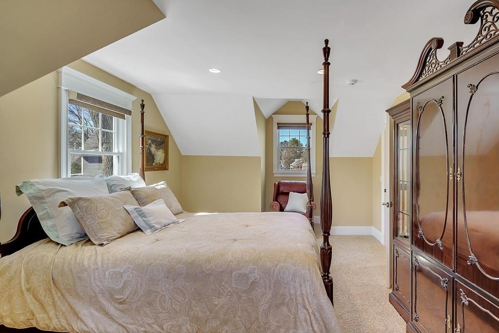 33 Everett Street Concord, MA 01742 - Photo 36 of 42 a bedroom with a bed window and a walk in closet