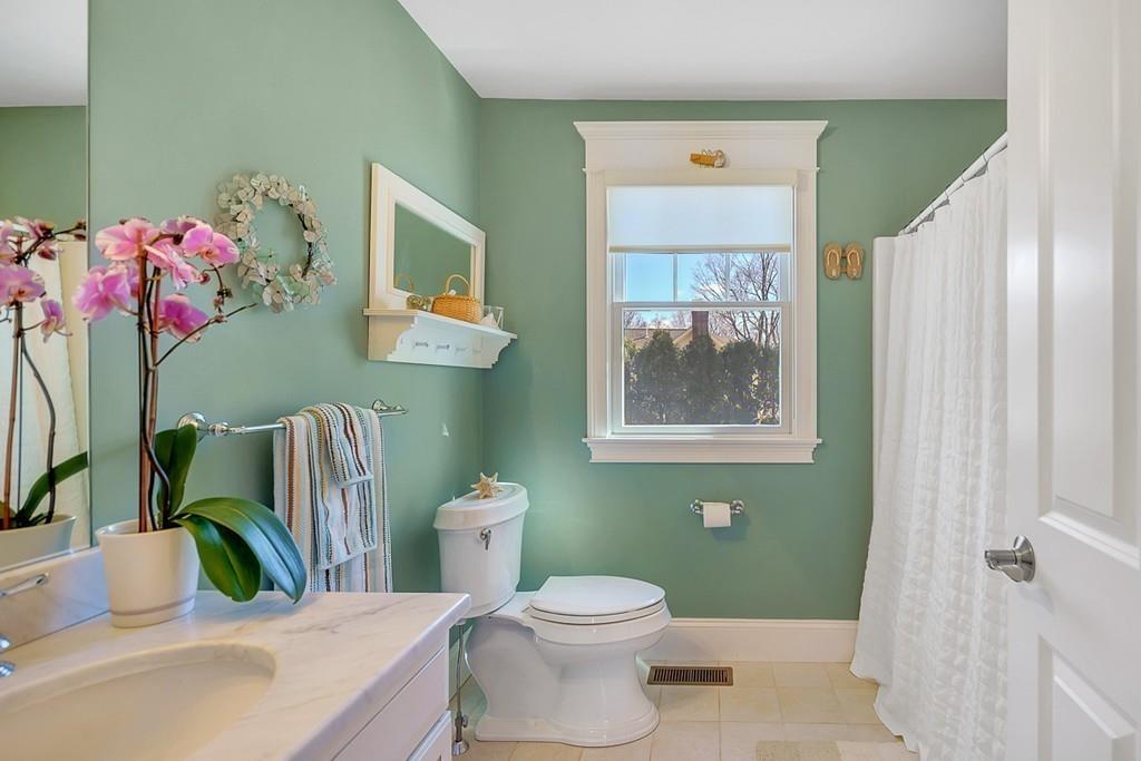 33 Everett Street Concord, MA 01742 - Photo 37 of 42 a bathroom with a toilet sink and mirror