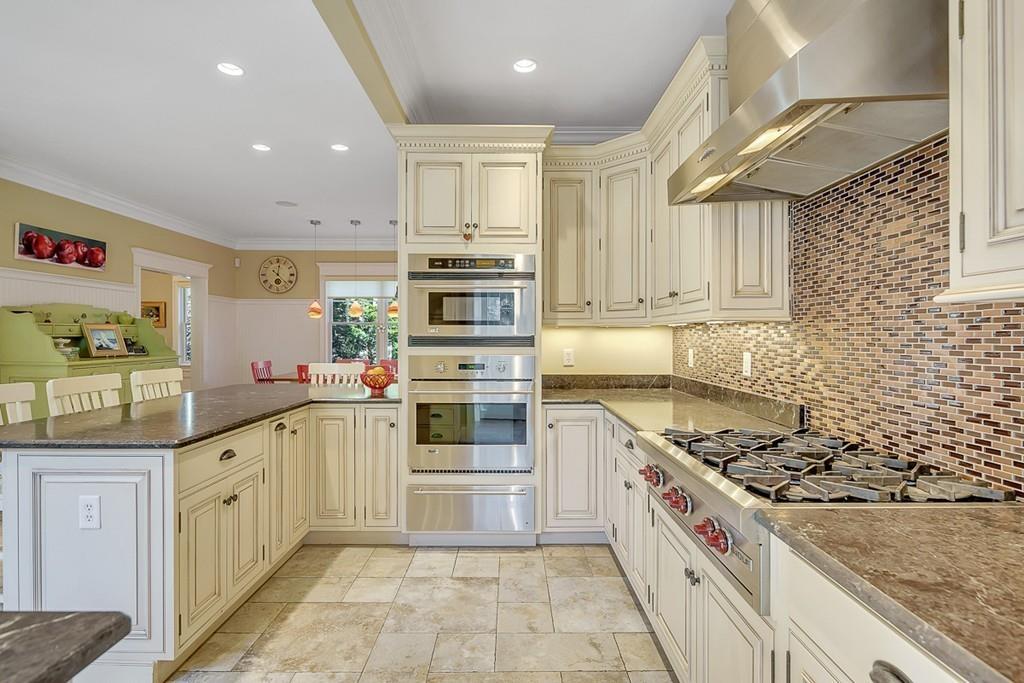 33 Everett Street Concord, MA 01742 - Photo 4 of 42 a kitchen with stainless steel appliances granite countertop a stove and a sink