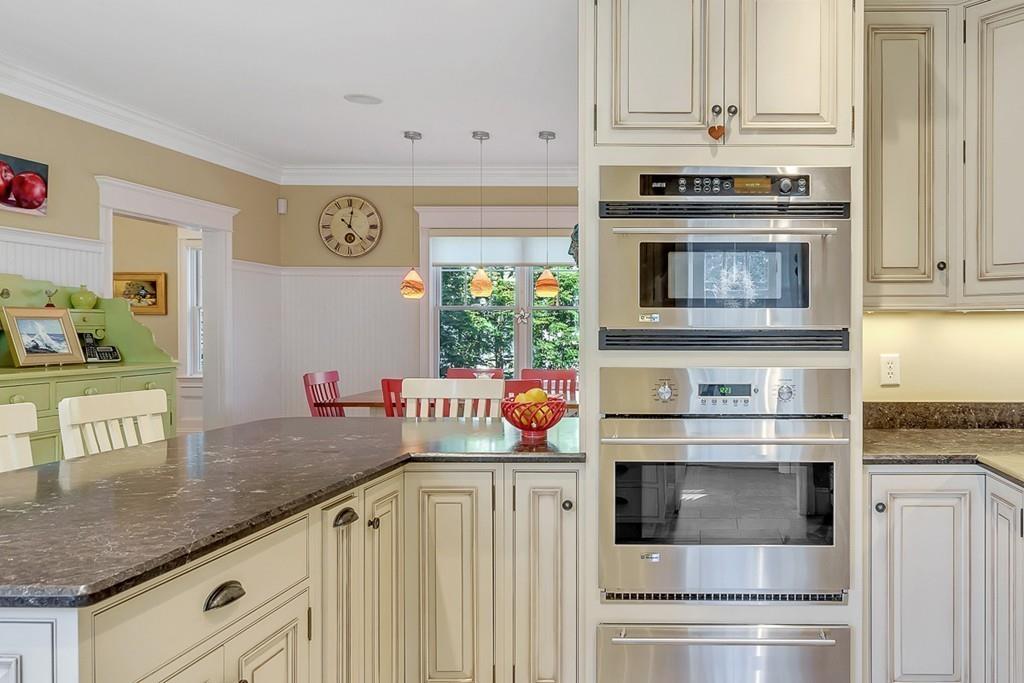 33 Everett Street Concord, MA 01742 - Photo 5 of 42 a kitchen with stainless steel appliances granite countertop a stove and cabinets