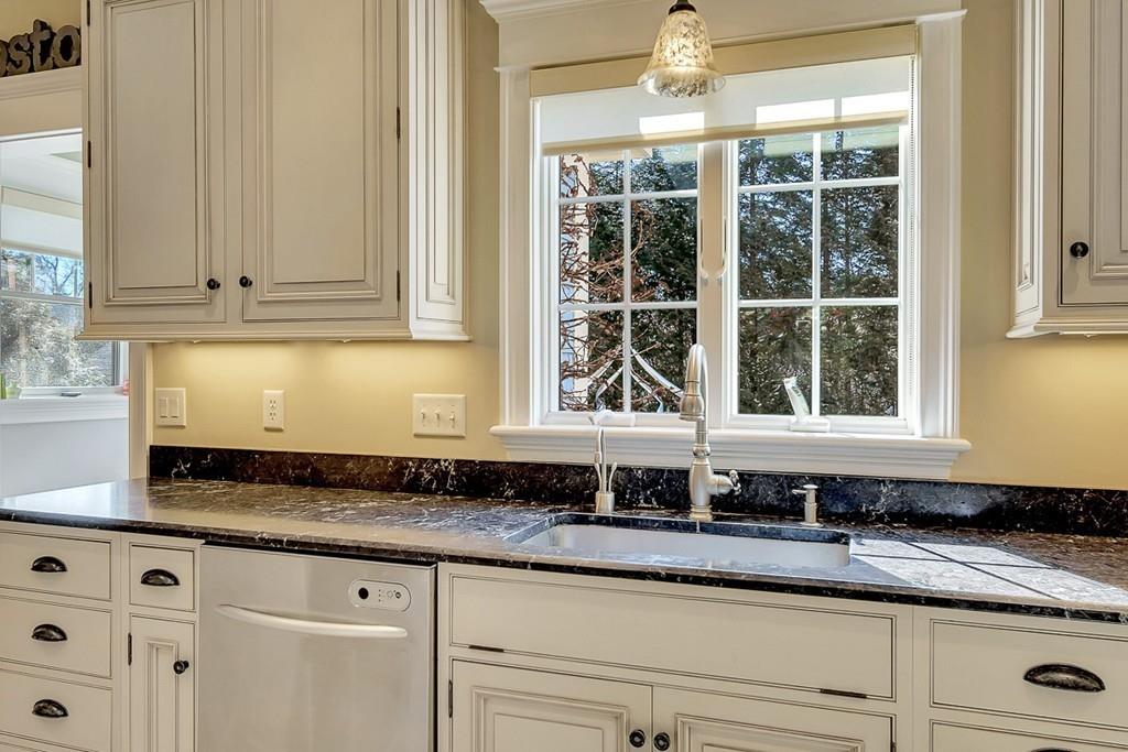 33 Everett Street Concord, MA 01742 - Photo 7 of 42 a kitchen with granite countertop a sink window and cabinets
