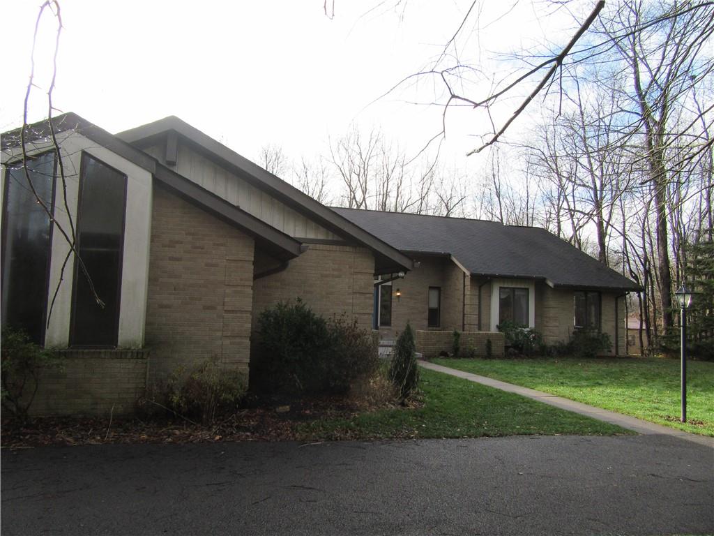 414 Klein Road Rochester, PA 15074 - Photo 1 of 37 a front view of a house with a garden and trees