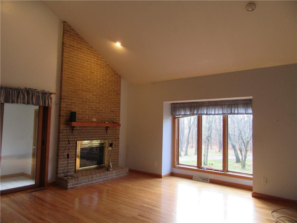 414 Klein Road Rochester, PA 15074 - Photo 11 of 37 a view of an empty room with a fireplace and a window