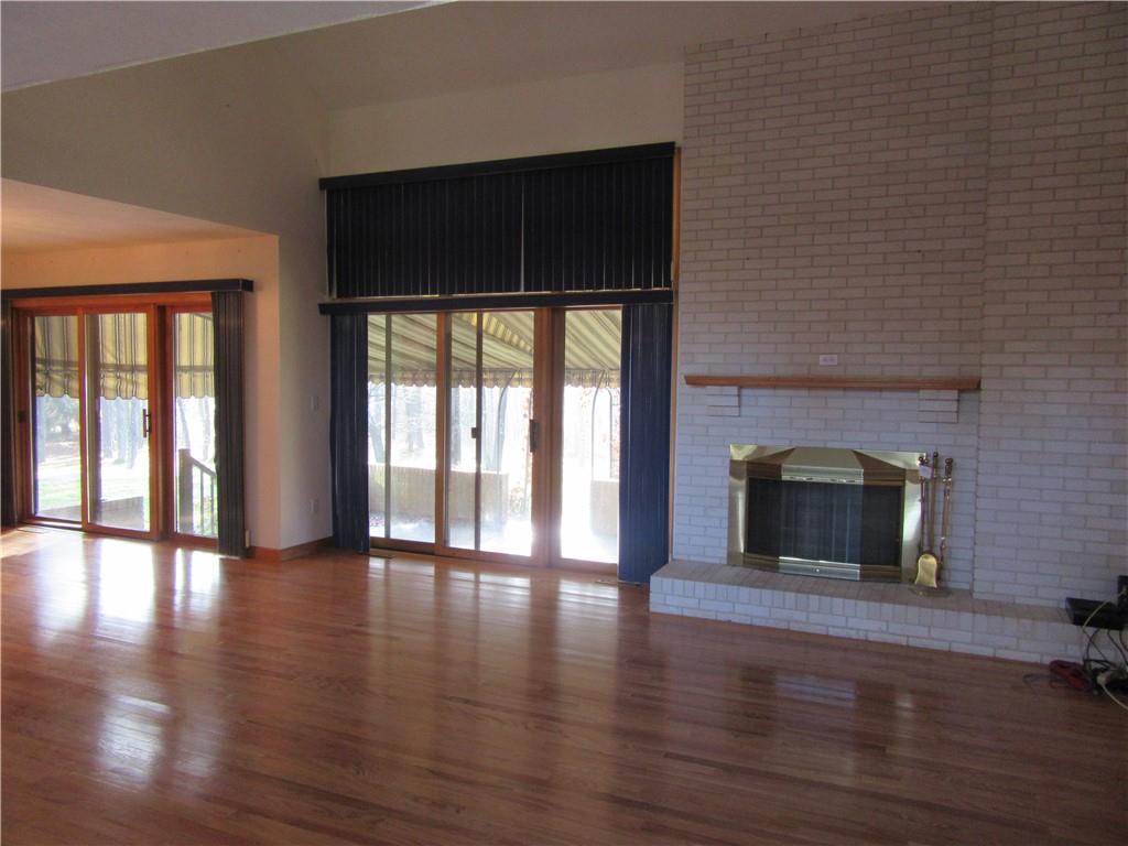 414 Klein Road Rochester, PA 15074 - Photo 5 of 37 an empty room with wooden floor and fireplace