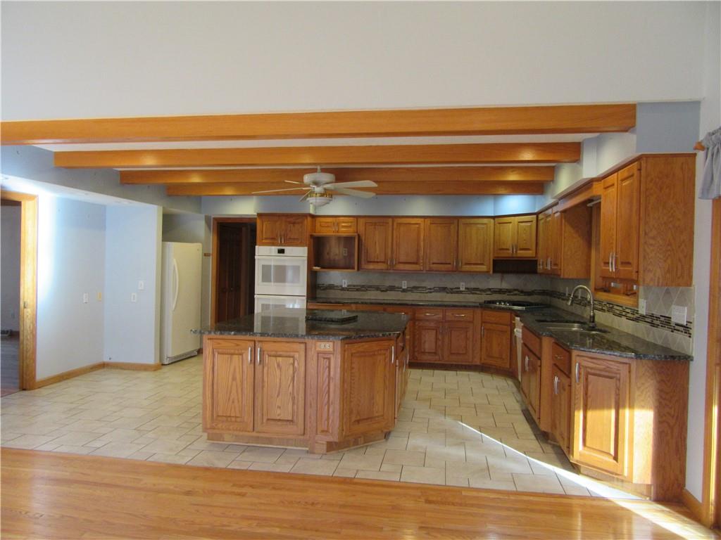 414 Klein Road Rochester, PA 15074 - Photo 8 of 37 a kitchen with stainless steel appliances granite countertop a stove and a refrigerator