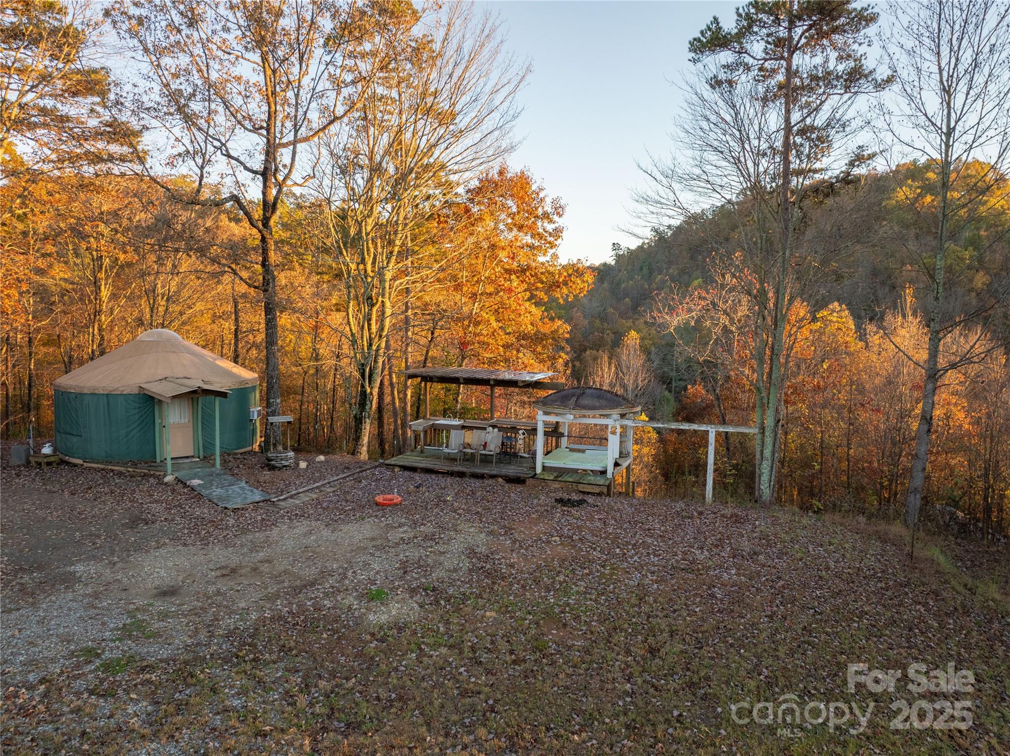 85 Brown Lane Marble, NC 28905 - Photo 14 of 32 a view of a house with large trees and wooden fence