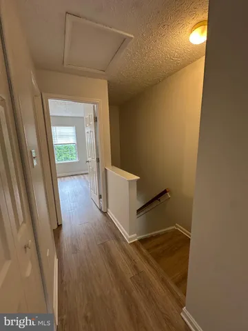 a view of hallway with wooden floor