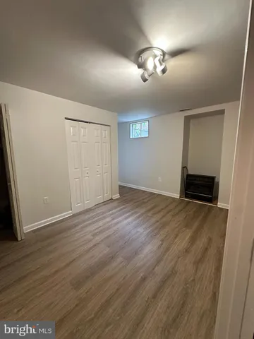 a kitchen with wooden floor and a refrigerator