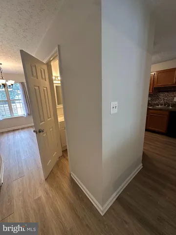 a view of a livingroom with wooden floor and staircase
