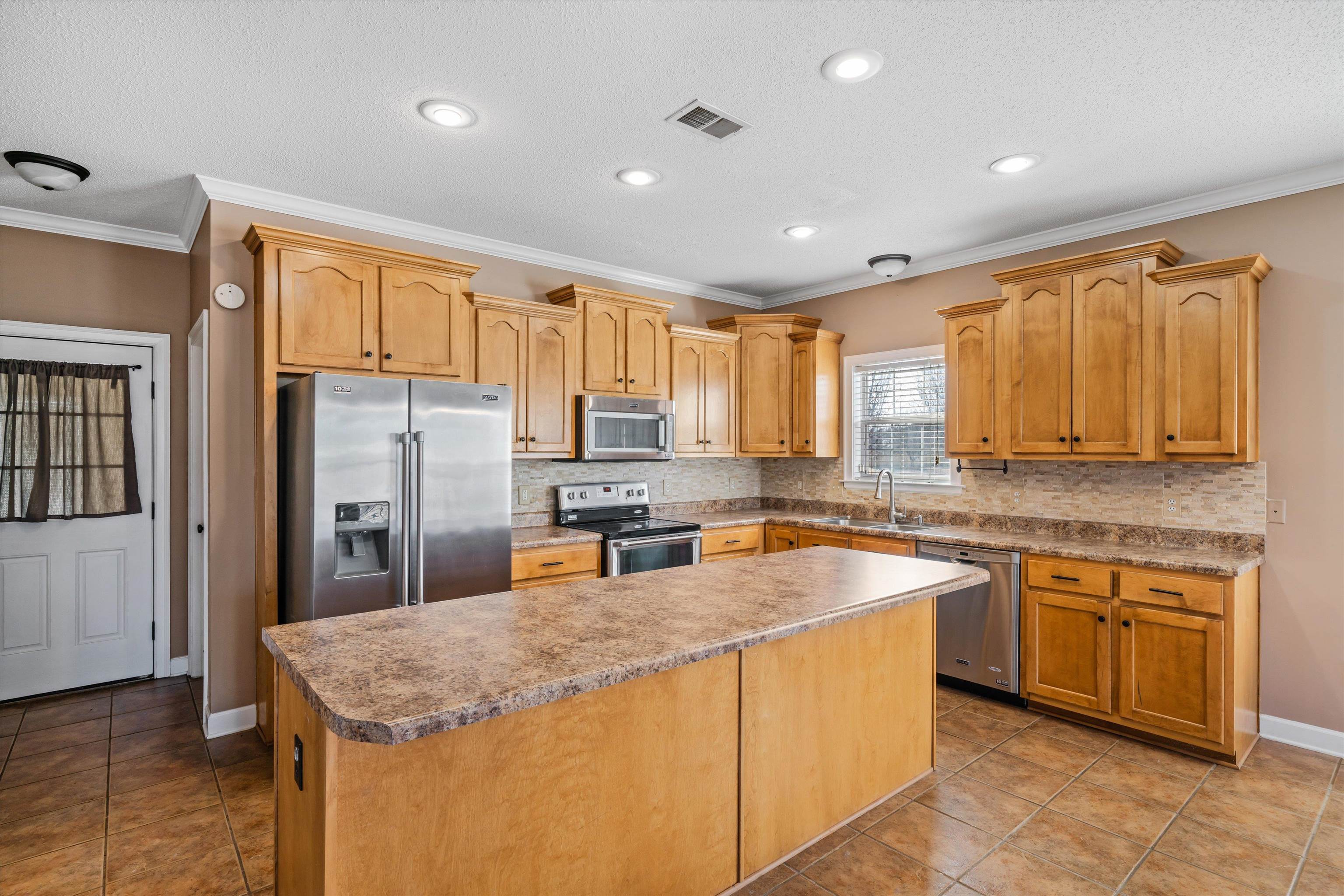 4972 Pleasant Ridge Drive Olive Branch, MS 38654 - Photo 12 of 24 a kitchen with stainless steel appliances granite countertop a sink a stove and refrigerator