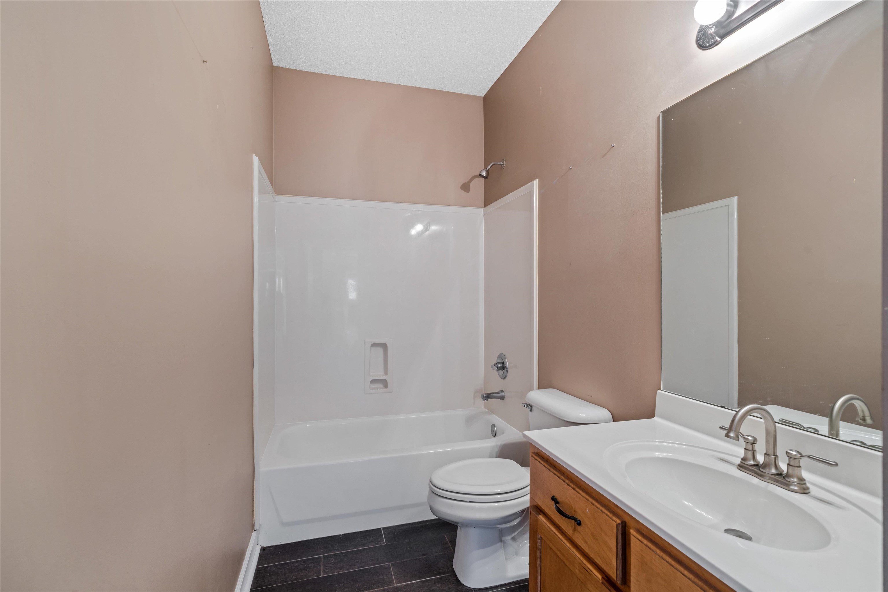 4972 Pleasant Ridge Drive Olive Branch, MS 38654 - Photo 19 of 24 a bathroom with a bathtub shower sink mirror vanity and toilet