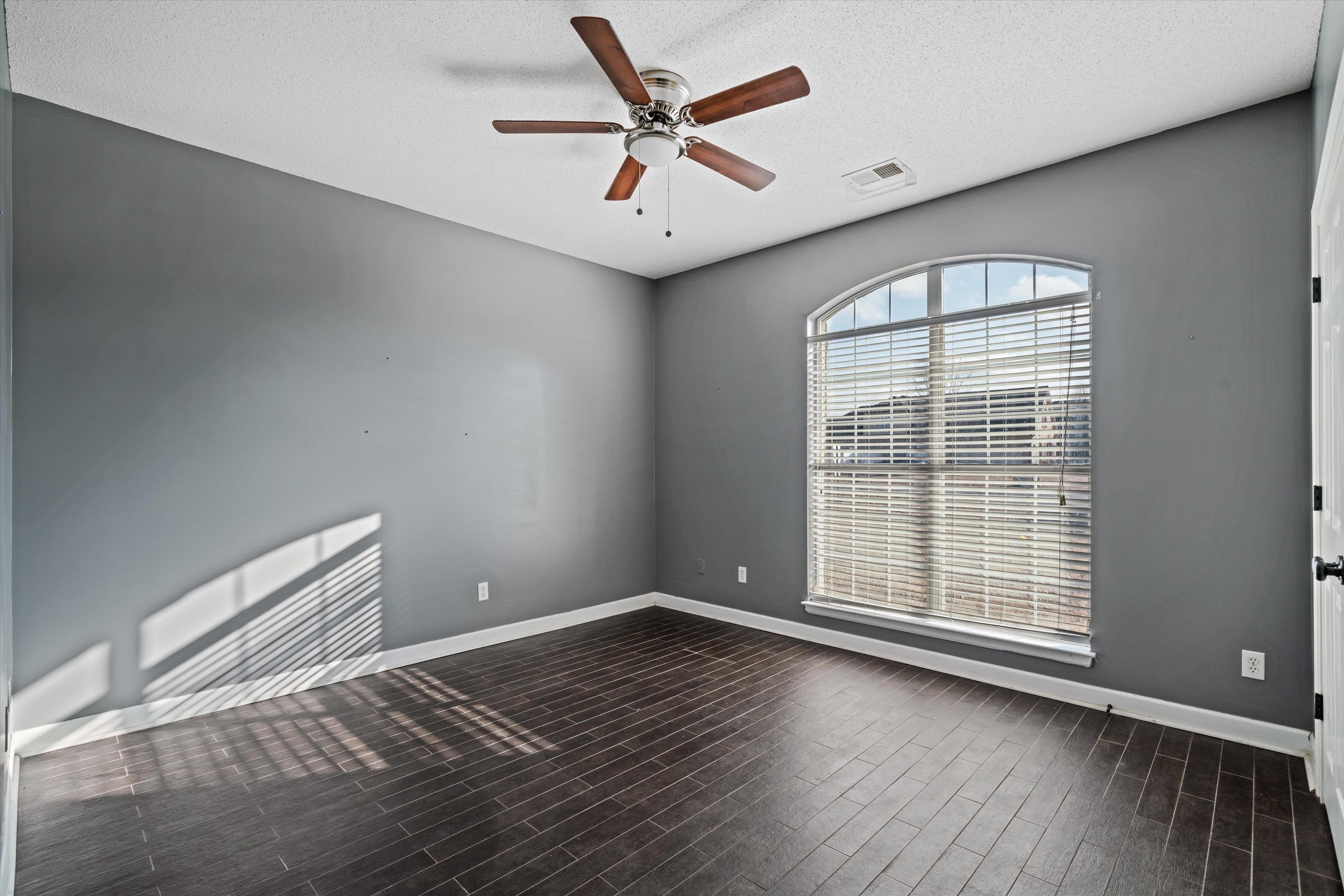 4972 Pleasant Ridge Drive Olive Branch, MS 38654 - Photo 20 of 24 an empty room with wooden floor and windows