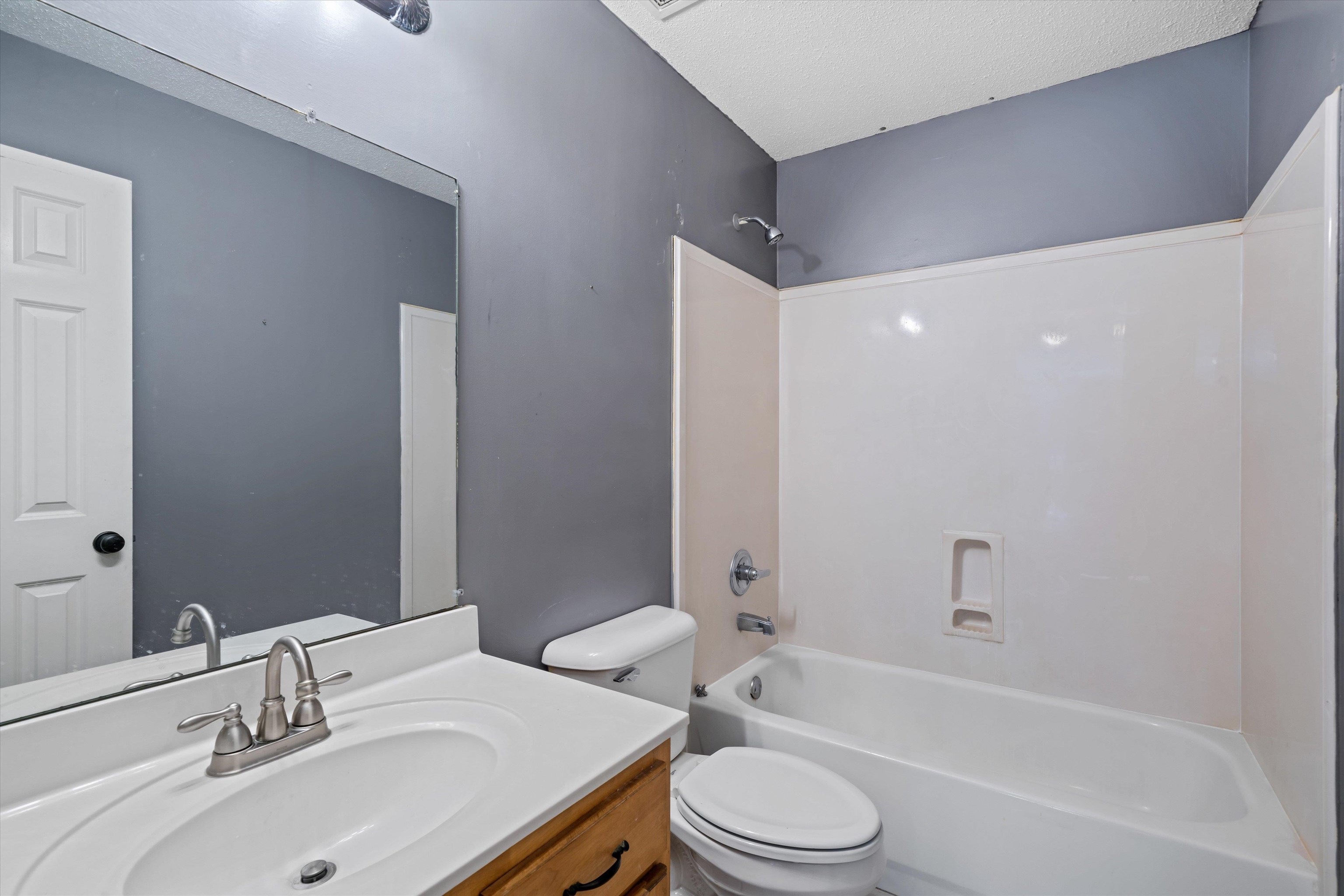 4972 Pleasant Ridge Drive Olive Branch, MS 38654 - Photo 24 of 24 a bathroom with a bathtub shower sink vanity mirror and toilet