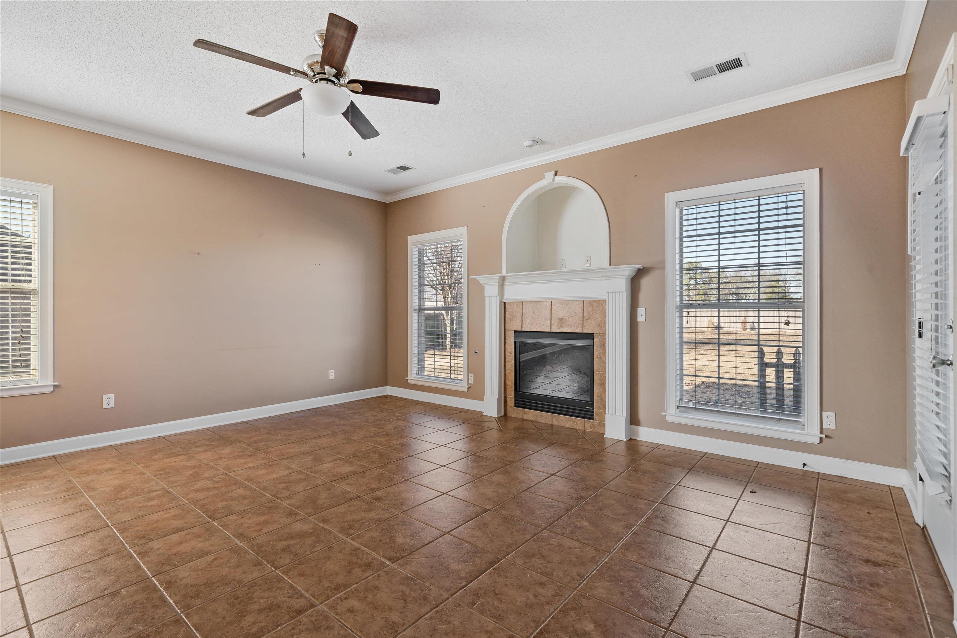 4972 Pleasant Ridge Drive Olive Branch, MS 38654 - Photo 9 of 24 a view of an empty room with a fireplace and a window